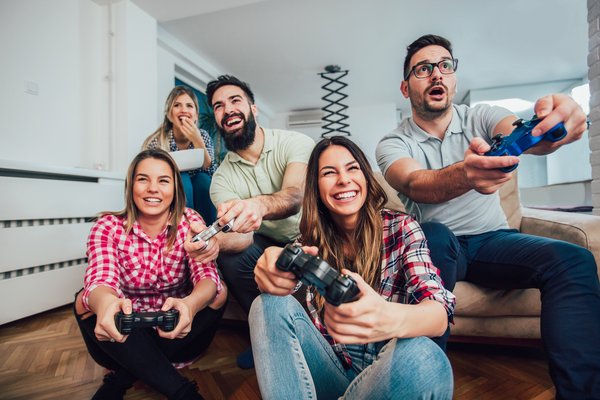 A group of adults enthusiastically playing a video game.