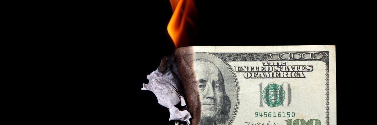 100 dollar bill burning -- wasting money cash