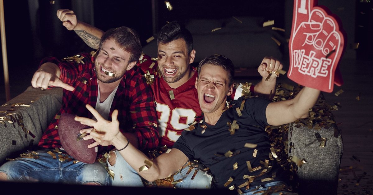 Men watching football on a television.