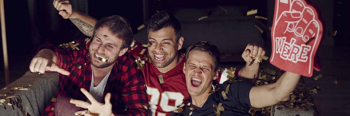 Men watching football on a television.