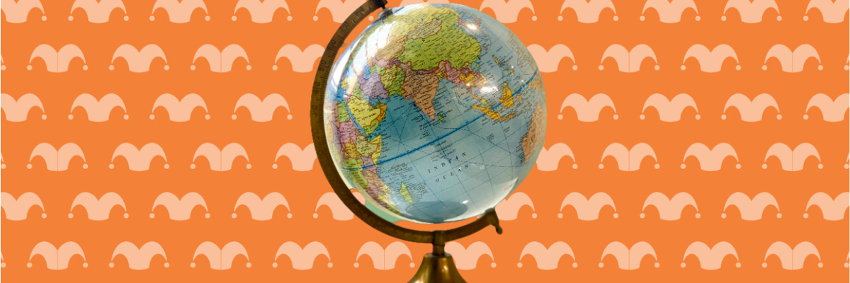 A globe in a stand against an orange background