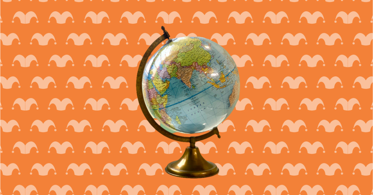 A globe in a stand against an orange background