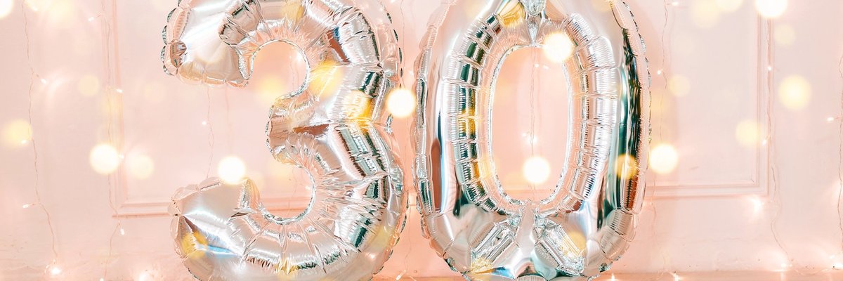 Silver balloons that say 30 and twinkle lights