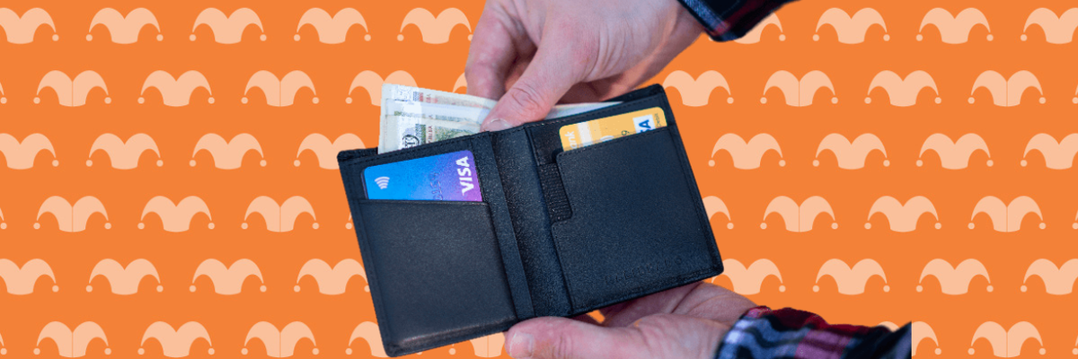Two hands holding a wallet taking cash out of it