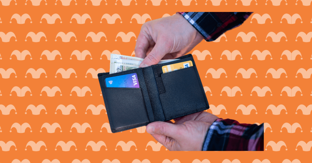 Two hands holding a wallet taking cash out of it
