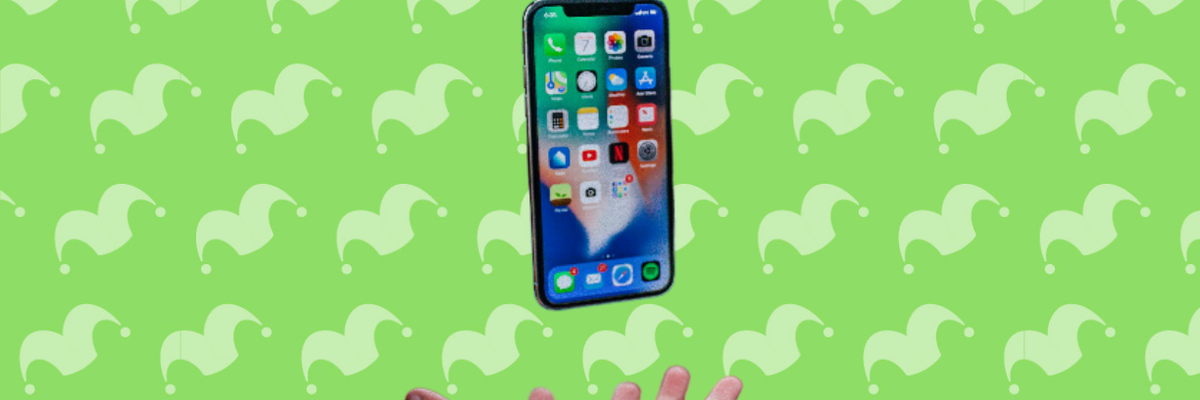 A hand tossing an iphone in the air