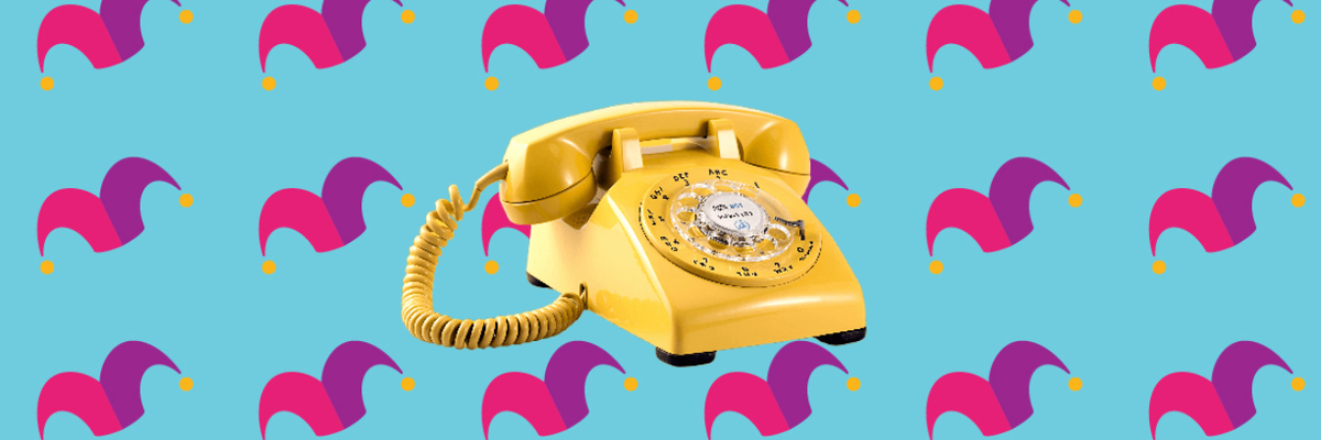A yellow rotary phone against a blue background