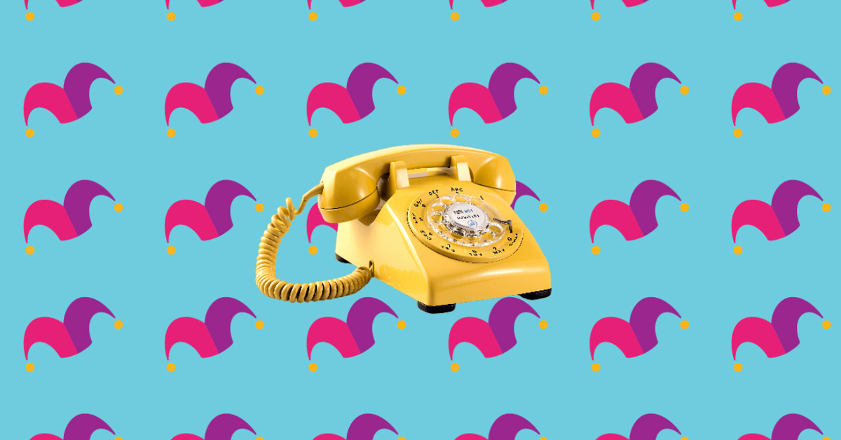 A yellow rotary phone against a blue background