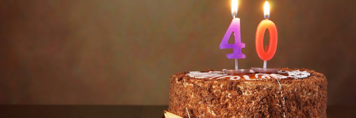 A chocolate birthday cake with candles that say 40.