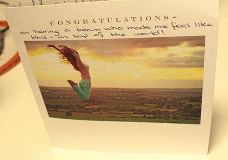 A thank-you card showing a customer jumping up in the air outdoors.