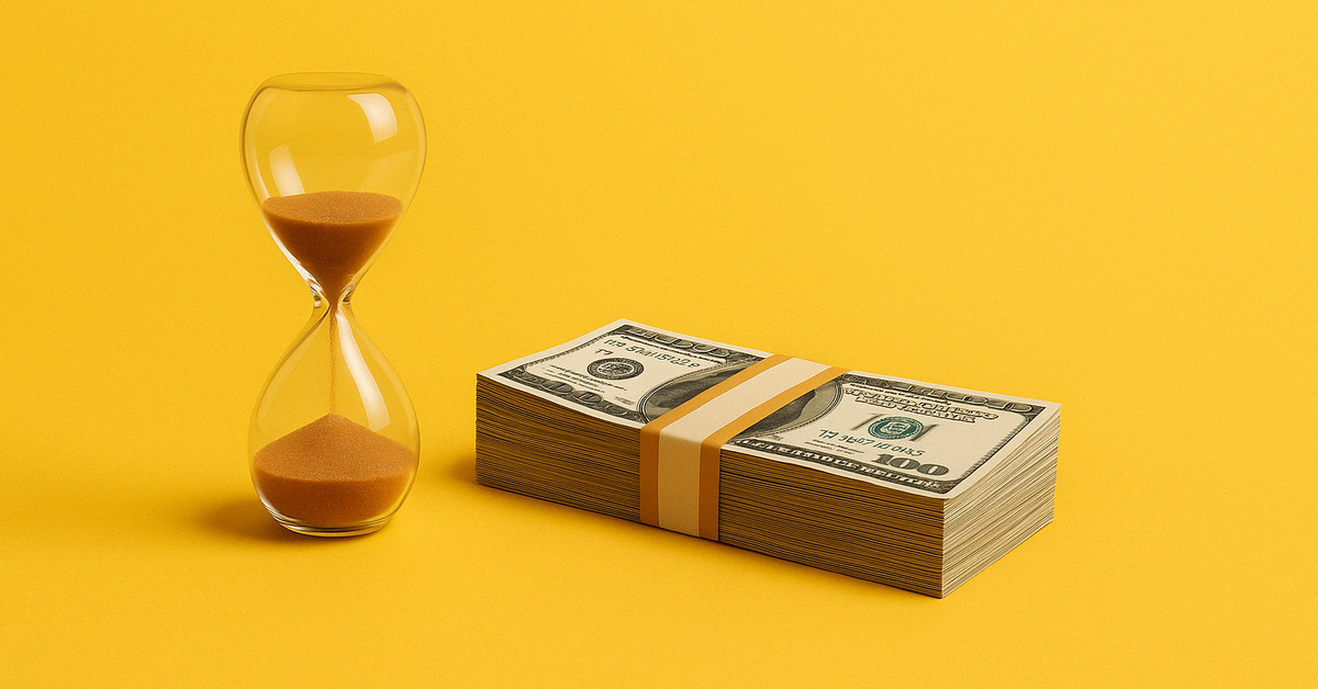 An hourglass next to a stack of cash.