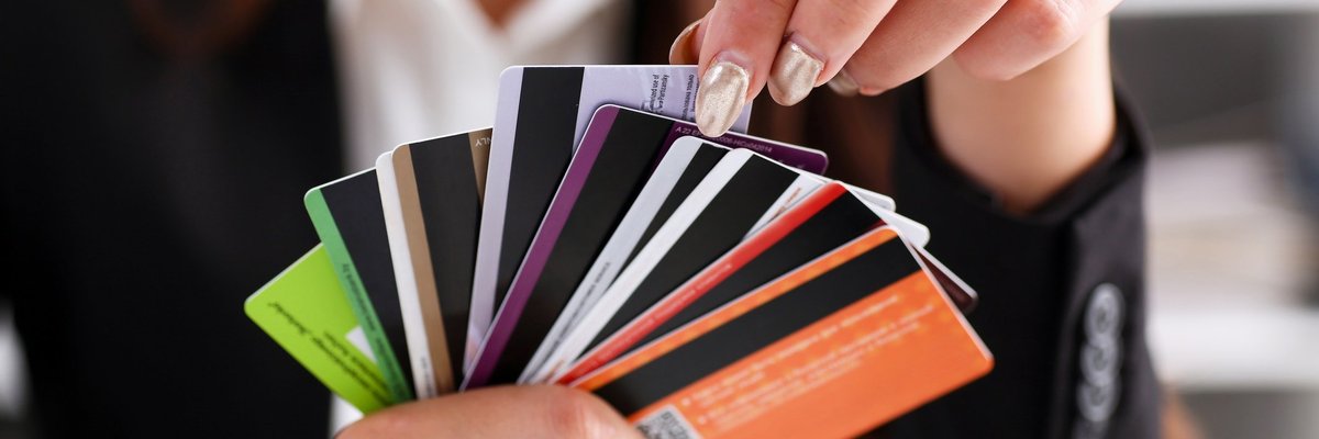 A person holding a fan of credit cards.