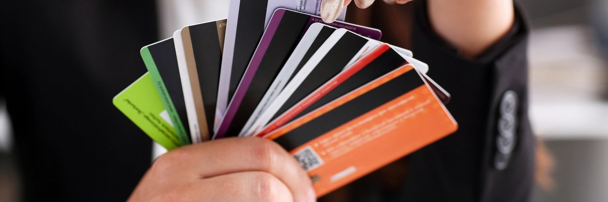 A person holding a fan of credit cards.