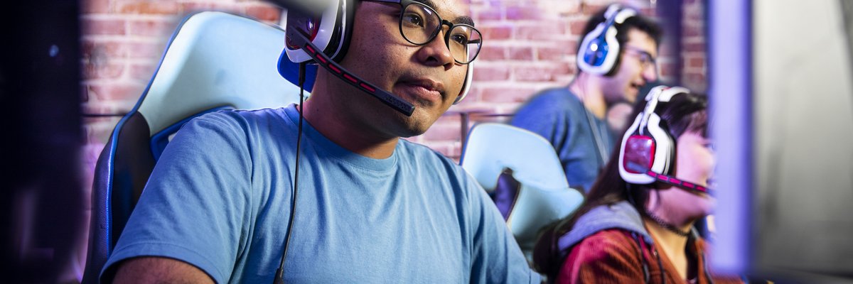 Adults engaging in computer gaming in a room together.