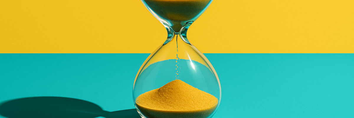 An hourglass in front of a blue and yellow background.