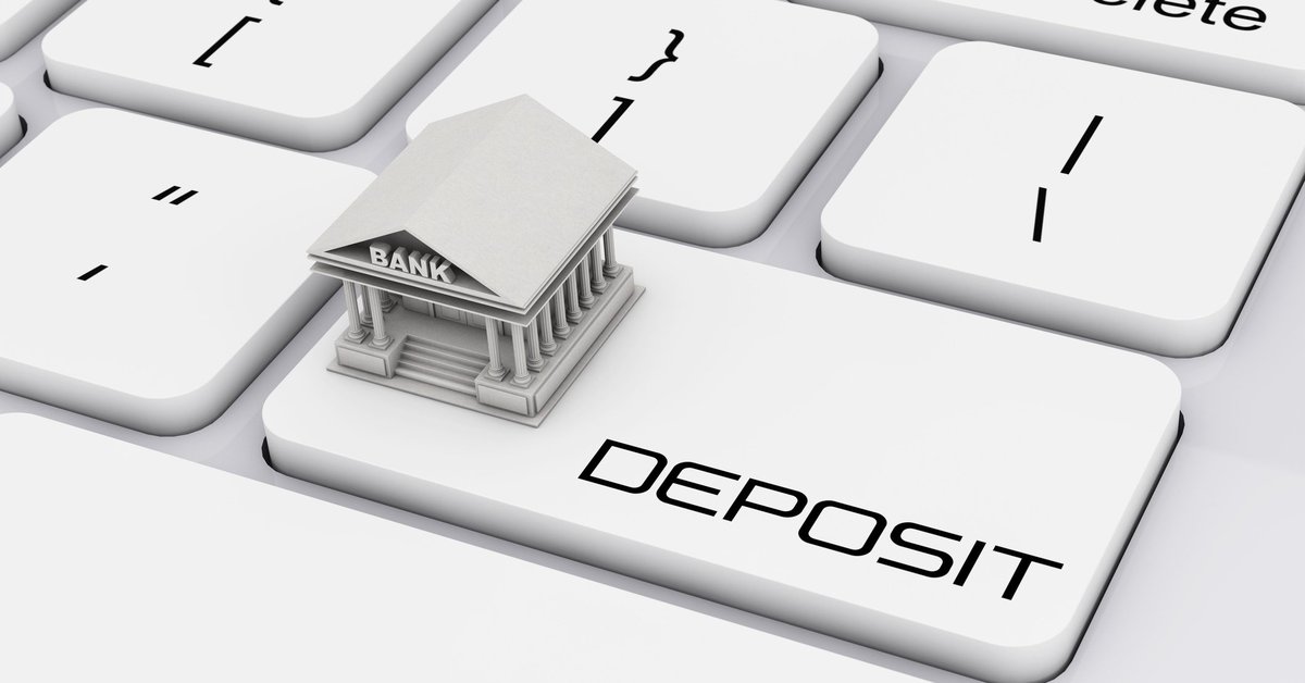 Keyboard with Deposit button and a bank on top of it.