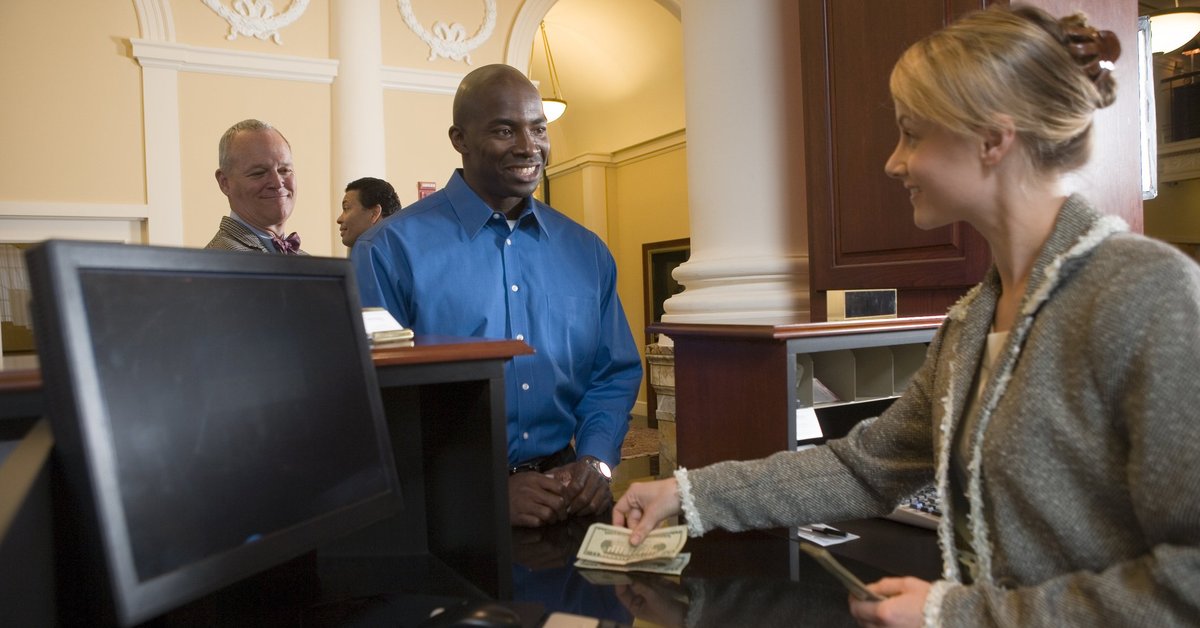 Bank teller assisting a customer with cash transaction.