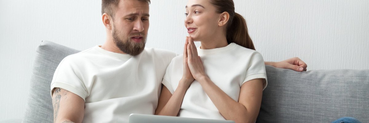 Woman Holding Hands Up In A Prayer Motion To Her Skeptical Boyfriend
