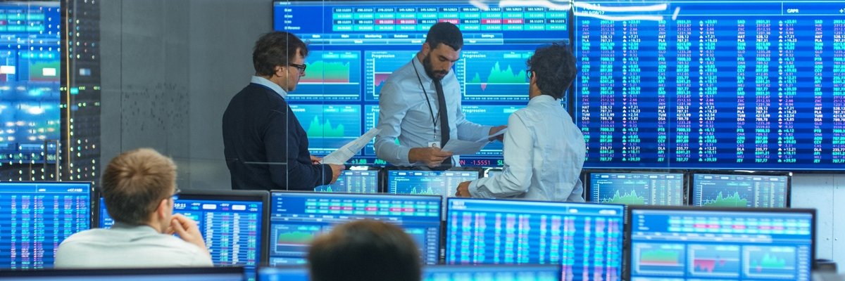 People review data in a room filled with computer screens