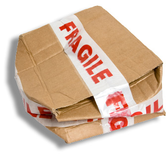 A crushed shipping box wrapped with tape labeled as fragile.
