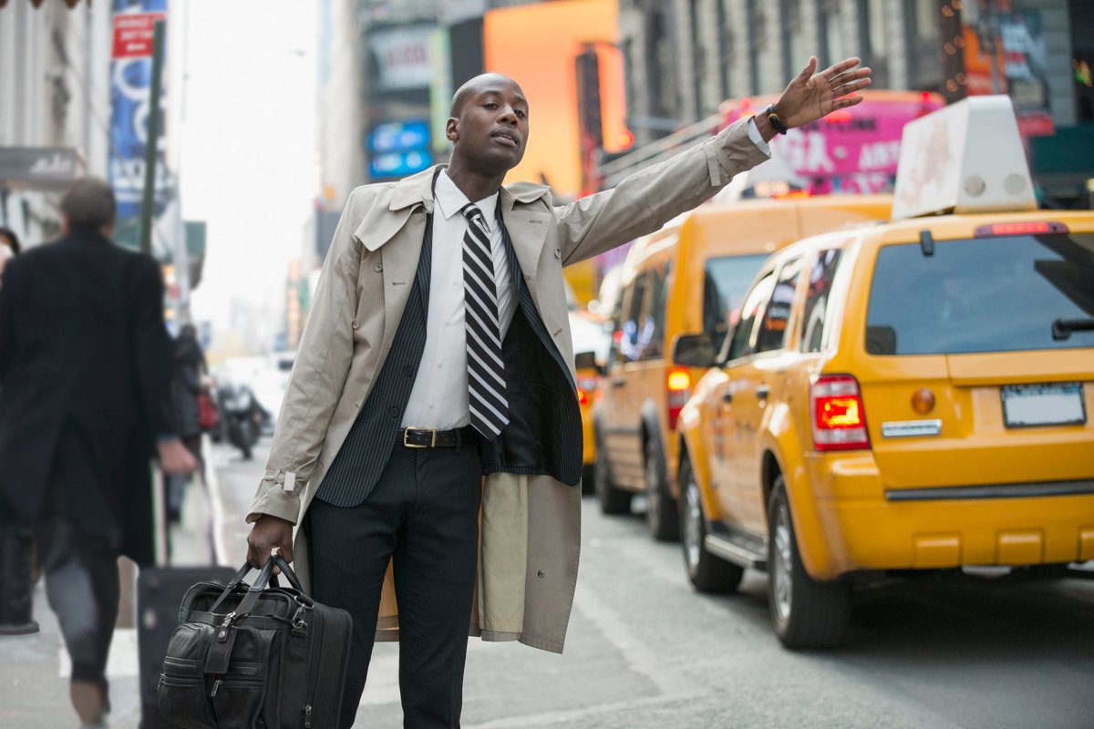 Businessman hailing a cab in the city.