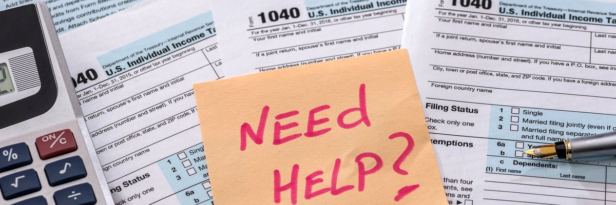 Stack of tax forms with post-it note reading Need Help? on top.