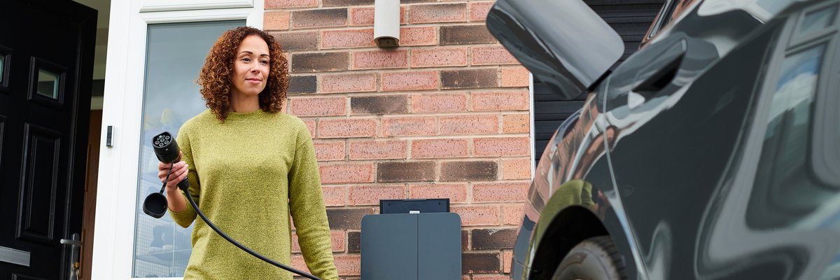 Car owner charging her EV or hybrid vehicle.