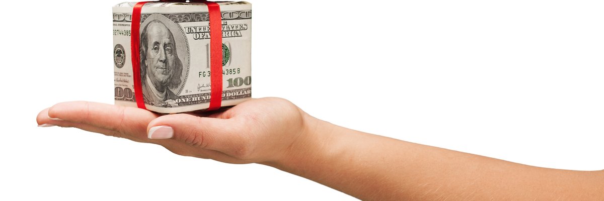 A hand holds a gift-wrapped box.