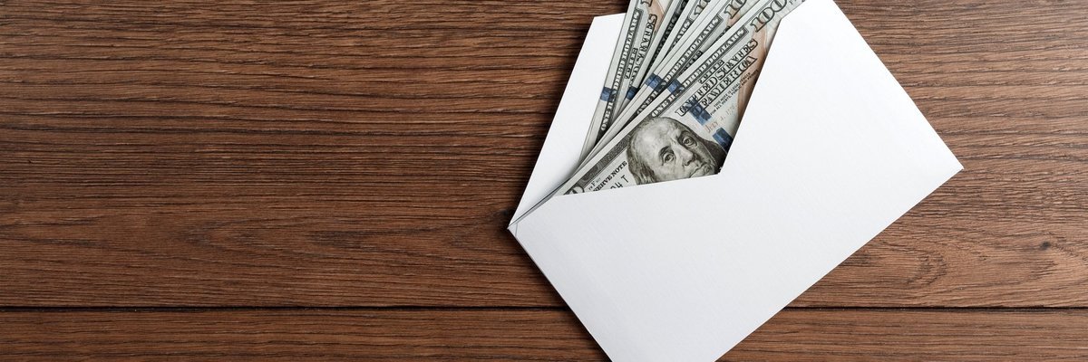 Several hundred-dollar bills in an envelope.