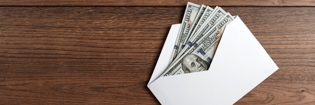 Several hundred-dollar bills in an envelope.