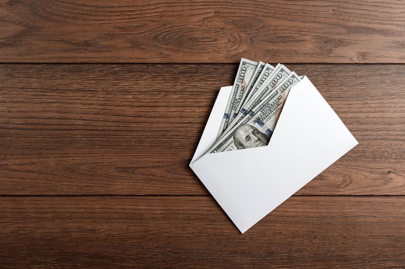Several hundred-dollar bills in an envelope.