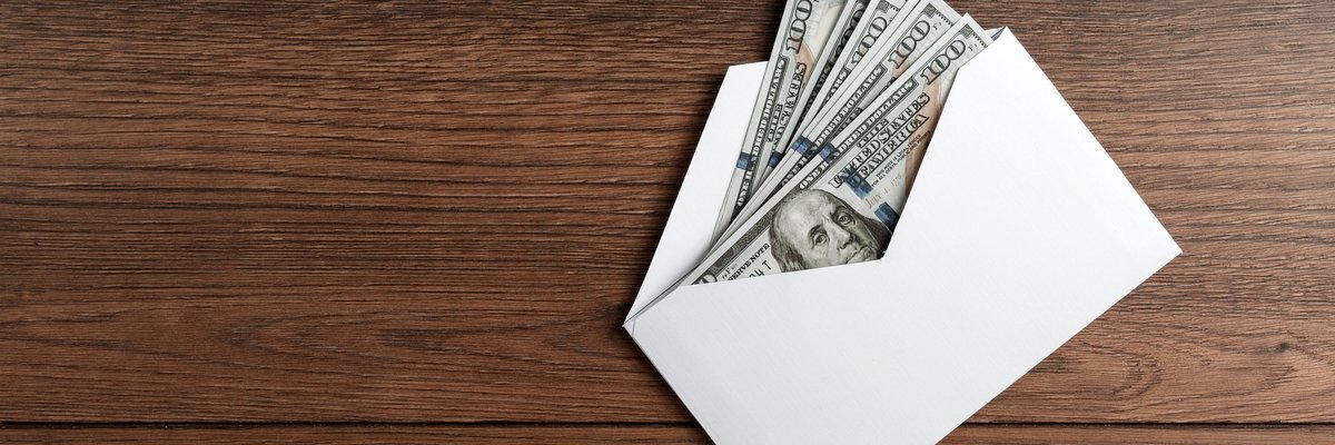 Several hundred-dollar bills in an envelope.
