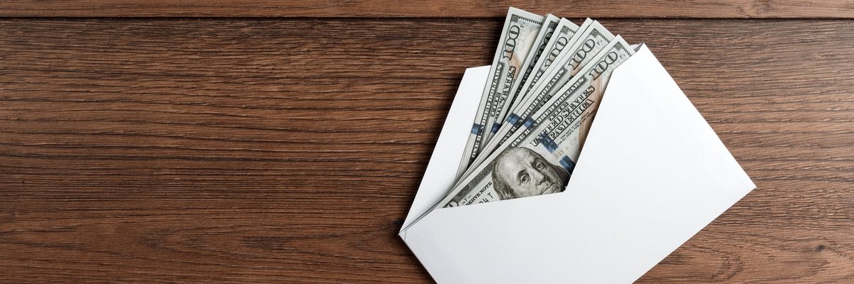 Several hundred-dollar bills in an envelope.