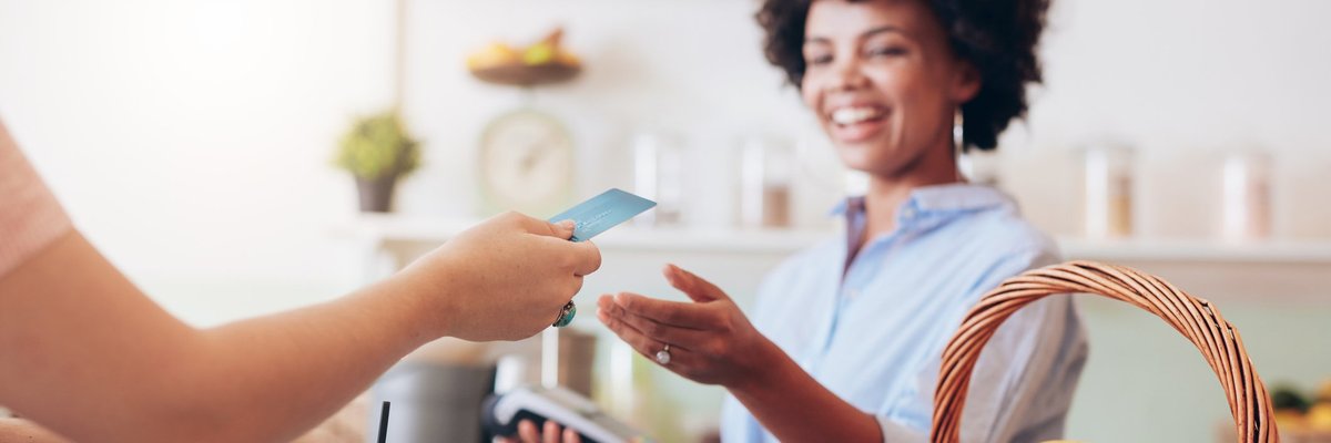 A cashier at a cafe running a credit card.