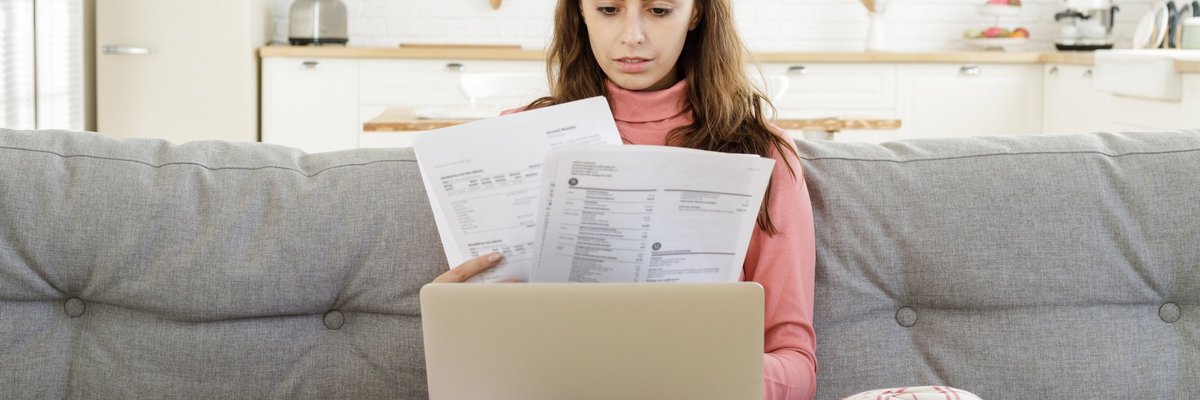Woman looking at confusing credit card documents
