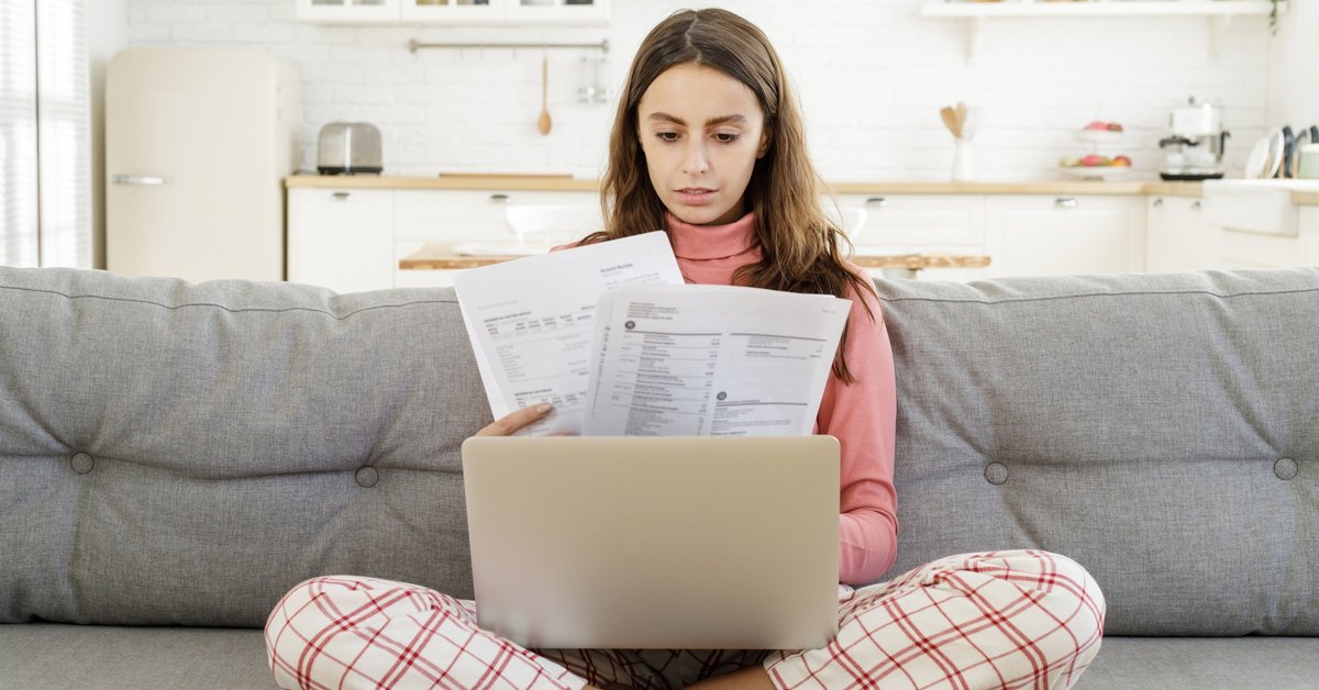 Woman looking at confusing credit card documents