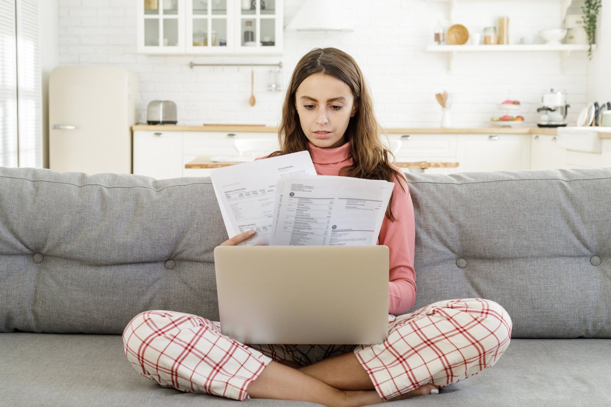 Woman looking at confusing credit card documents