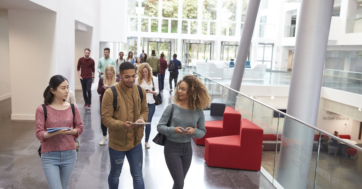 A group of college students walking out of class.