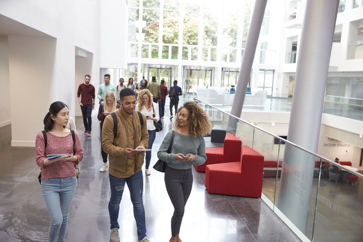 A group of college students walking out of class.