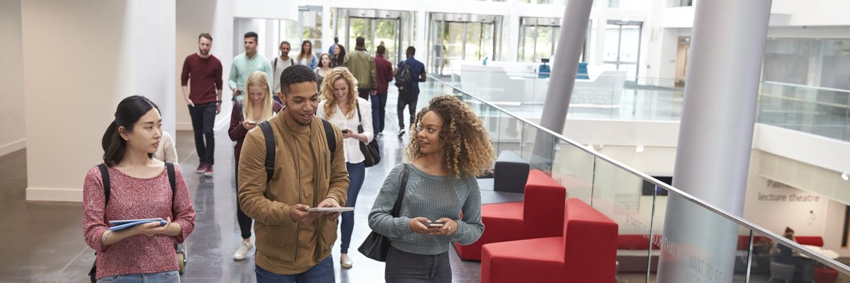 A group of college students walking out of class.