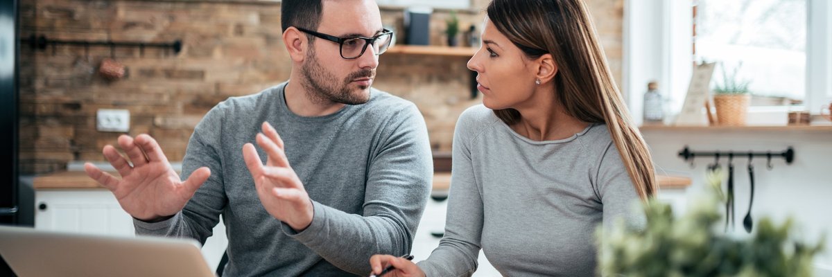 Couple Having A Discussion At Table