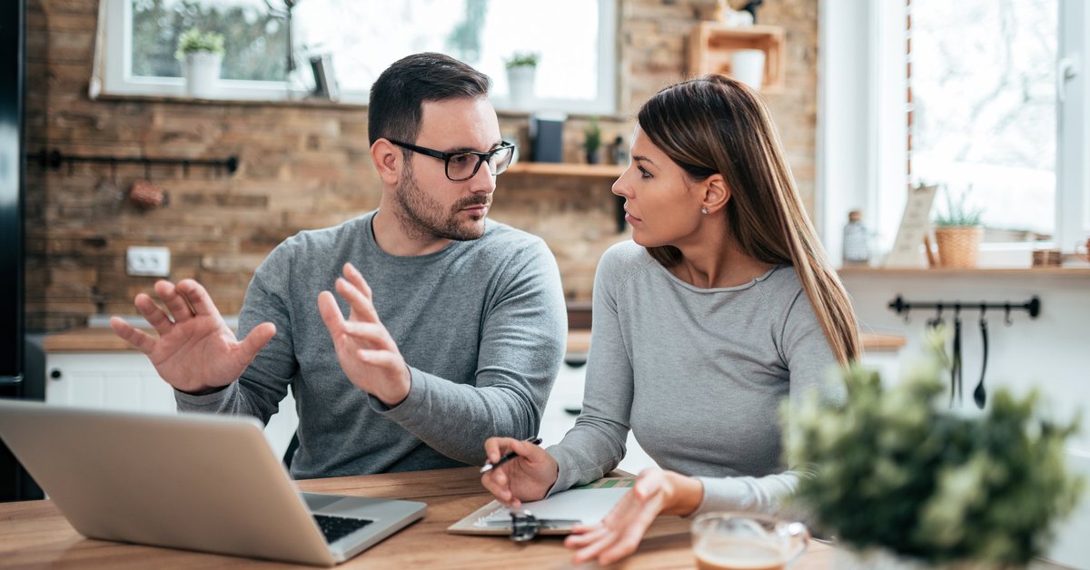 Couple Having A Discussion At Table