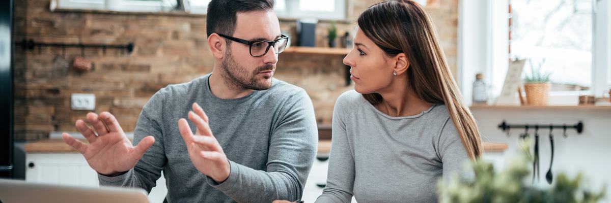 Couple Having A Discussion At Table