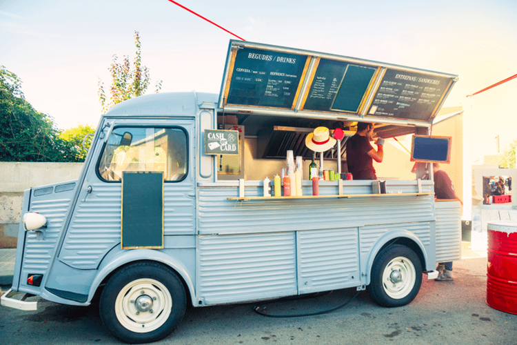 A food truck parked in a sunny spot.