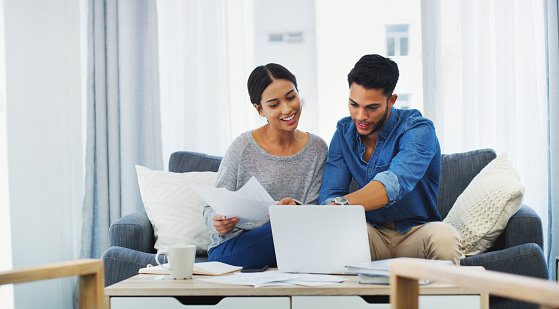 Couple Doing Paperwork With Laptop