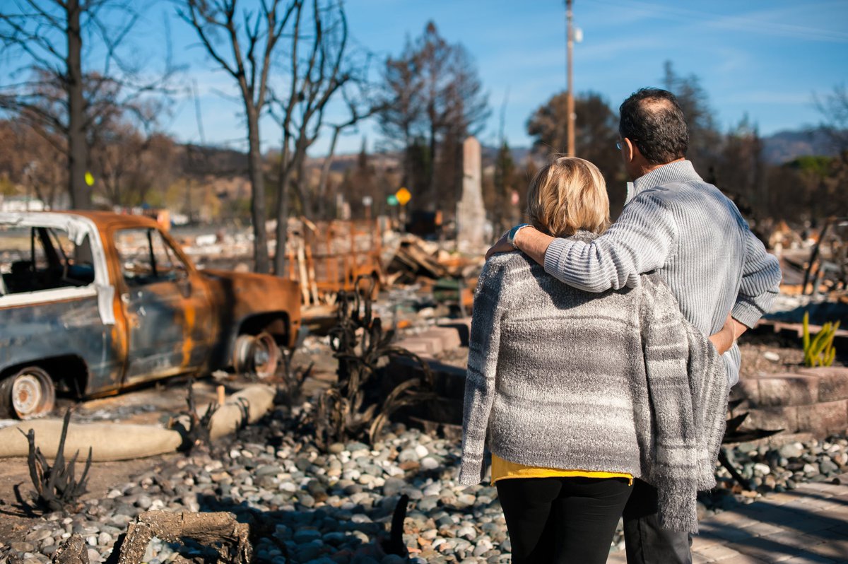 Couple checking the wreckage after the fire disaster.
