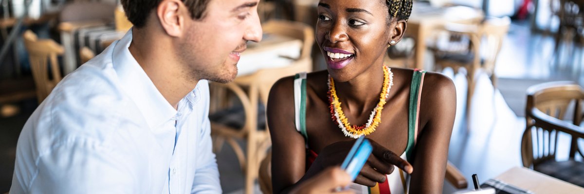 Couple has card out to pay in a restaurant.