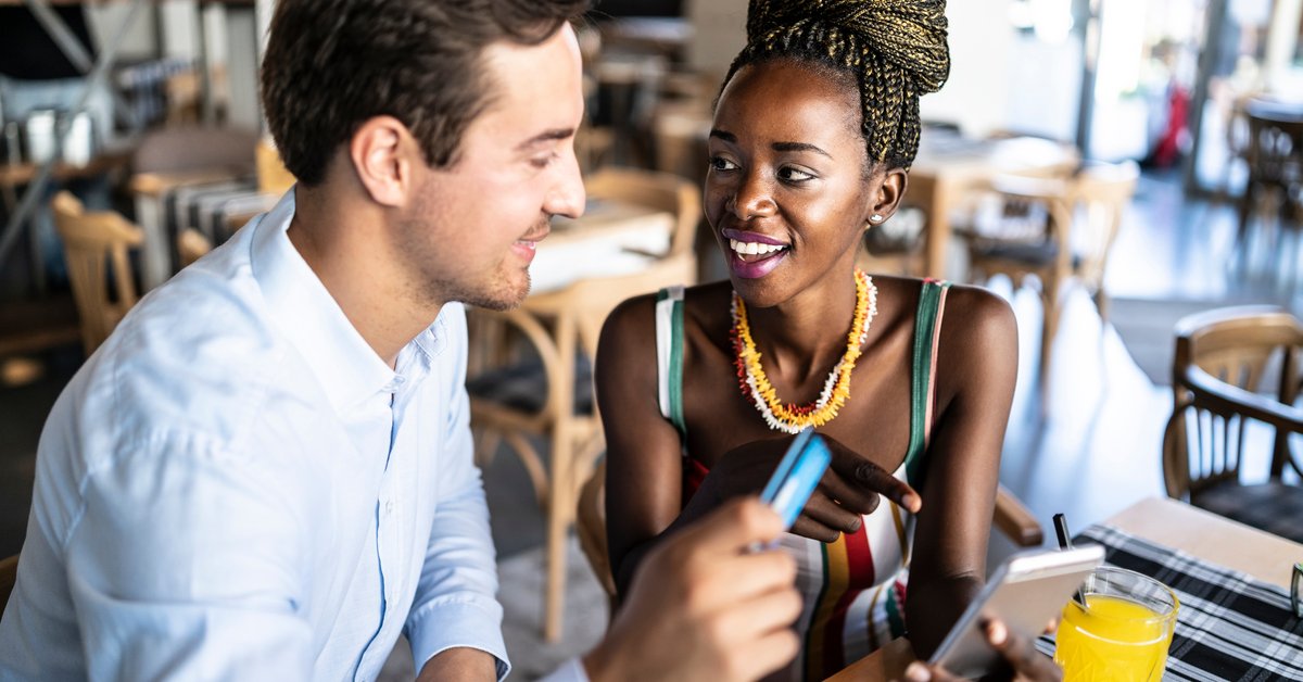 Couple has card out to pay in a restaurant.