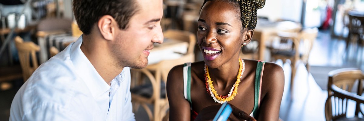 Couple has card out to pay in a restaurant.