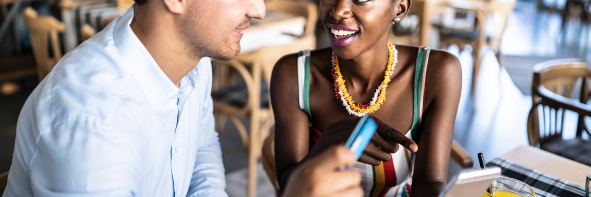 Couple has card out to pay in a restaurant.